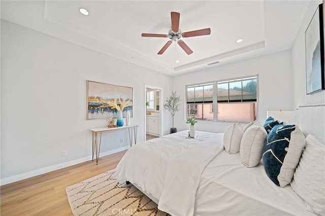 89 Overbrook, Irvine, CA 92620 - bedroom with a raised ceiling, light wood-style floors, multiple windows, recessed lighting, and ceiling fan