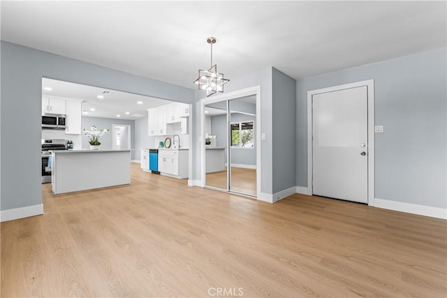 10352 Lincoln Ave, Hesperia, CA 92345 - unfurnished living room with recessed lighting, a chandelier, and light wood-type flooring