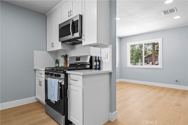 10352 Lincoln Ave, Hesperia, CA 92345 - kitchen featuring stainless steel appliances, light countertops, light wood-type flooring, white cabinetry, and recessed lighting