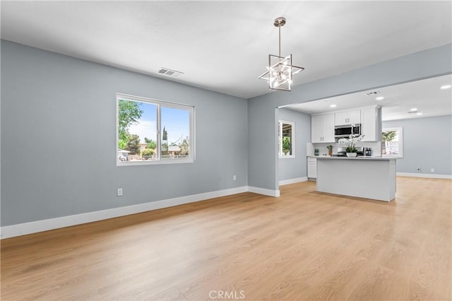10352 Lincoln Ave, Hesperia, CA 92345 - unfurnished living room featuring healthy amount of natural light, light wood-type flooring, and recessed lighting