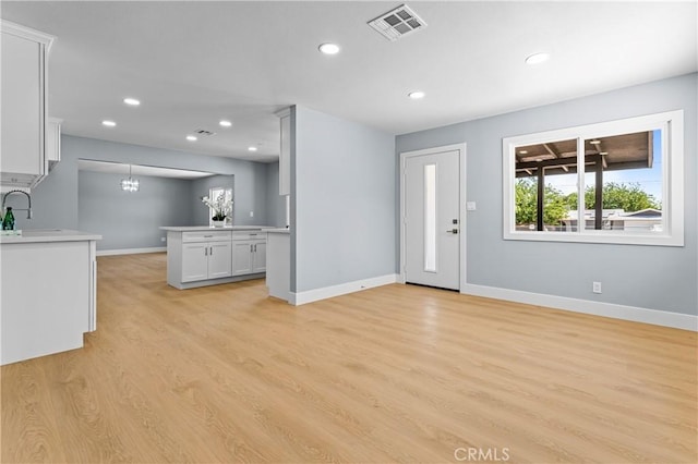 10352 Lincoln Ave, Hesperia, CA 92345 - unfurnished living room featuring light wood-style floors, recessed lighting, and a chandelier