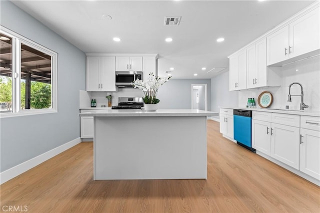 10352 Lincoln Ave, Hesperia, CA 92345 - kitchen with stainless steel appliances, light countertops, white cabinetry, and recessed lighting