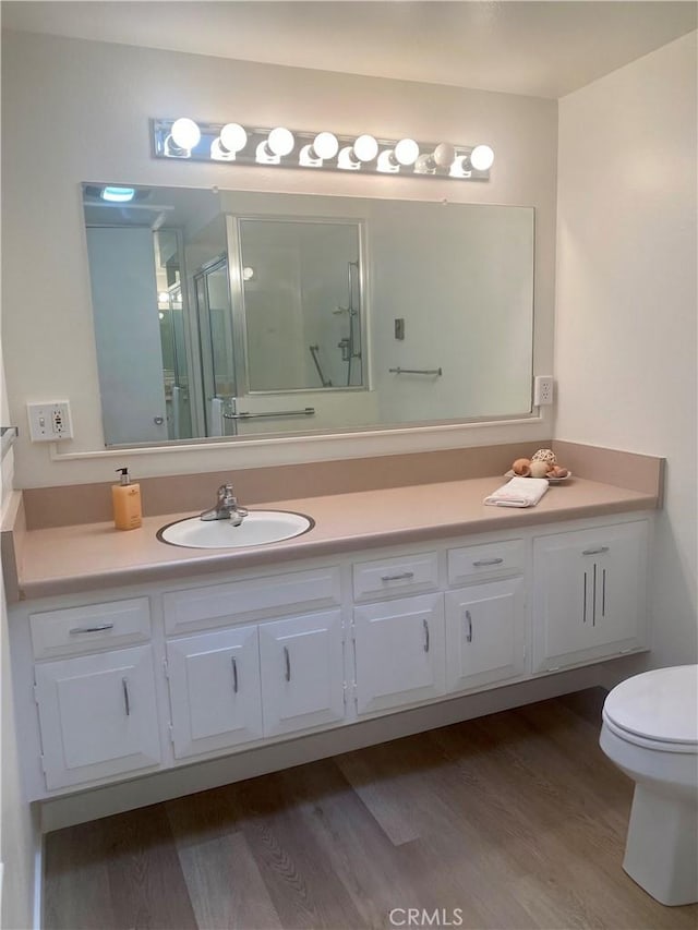1871 Golden Rain Rd Unit M14-26H, Seal Beach, CA 90740 - full bath featuring vanity, a stall shower, and wood finished floors