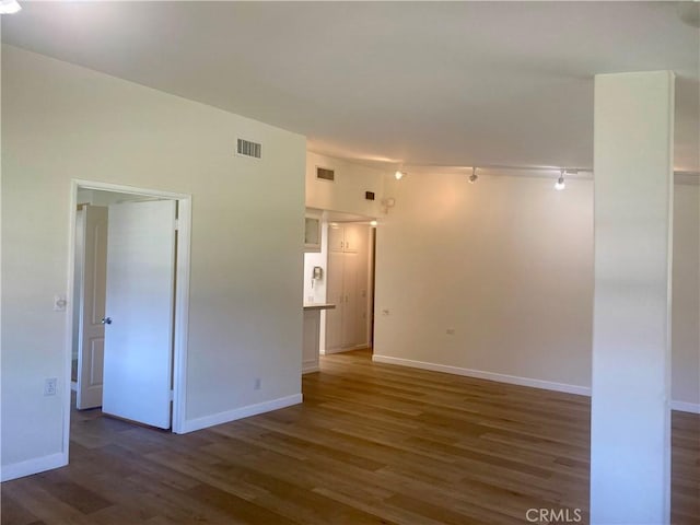 1871 Golden Rain Rd Unit M14-26H, Seal Beach, CA 90740 - unfurnished room featuring wood finished floors and rail lighting
