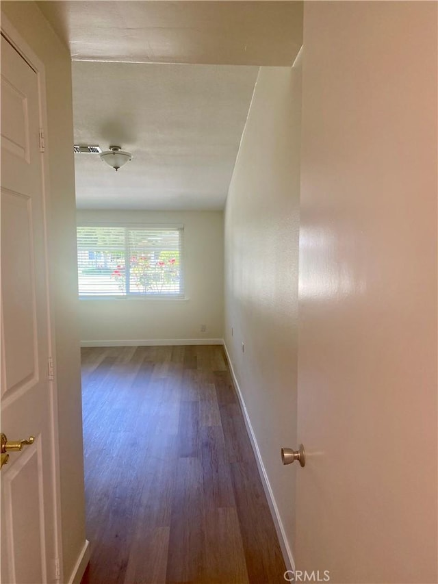 1871 Golden Rain Rd Unit M14-26H, Seal Beach, CA 90740 - unfurnished room with wood finished floors and baseboards
