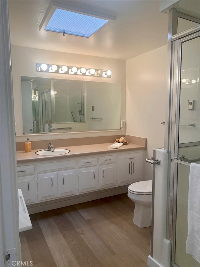 1871 Golden Rain Rd Unit M14-26H, Seal Beach, CA 90740 - bathroom with wood finished floors, vanity, and a shower stall