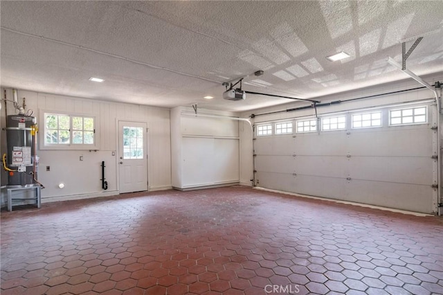 6210 Riverside Ave, Rialto, CA 92377 - garage with secured water heater and a garage door opener