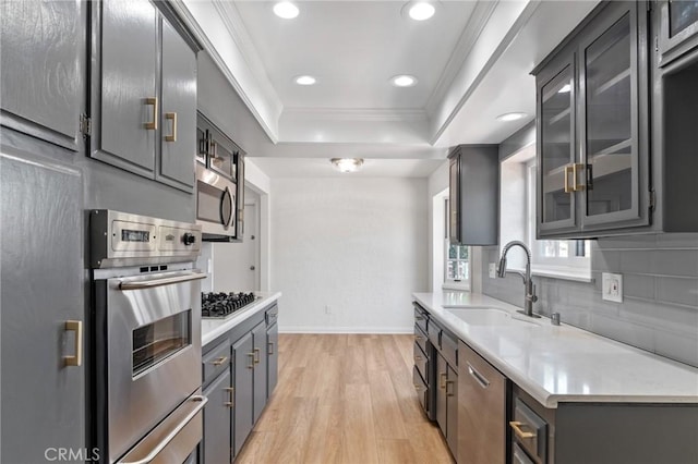 6210 Riverside Ave, Rialto, CA 92377 - kitchen with a tray ceiling, stainless steel appliances, light wood-style floors, recessed lighting, and decorative backsplash