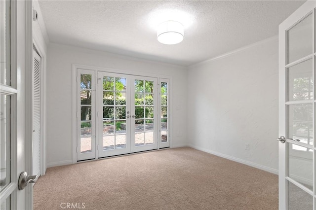 6210 Riverside Ave, Rialto, CA 92377 - unfurnished room featuring french doors, carpet, and a textured ceiling