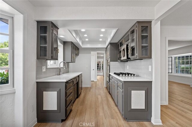 6210 Riverside Ave, Rialto, CA 92377 - kitchen featuring stainless steel appliances, light countertops, light wood-type flooring, backsplash, and recessed lighting