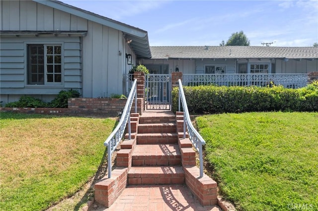 6210 Riverside Ave, Rialto, CA 92377 - view of front of property with board and batten siding and a front yard