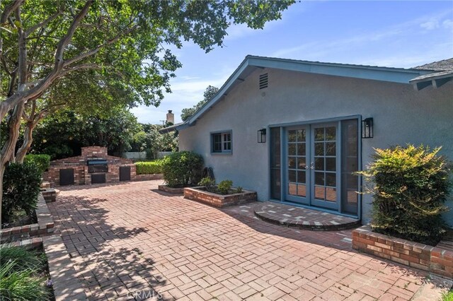 6210 Riverside Ave, Rialto, CA 92377 - view of patio featuring an outdoor brick fireplace and french doors