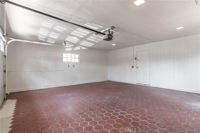 6210 Riverside Ave, Rialto, CA 92377 - garage featuring a garage door opener and baseboards