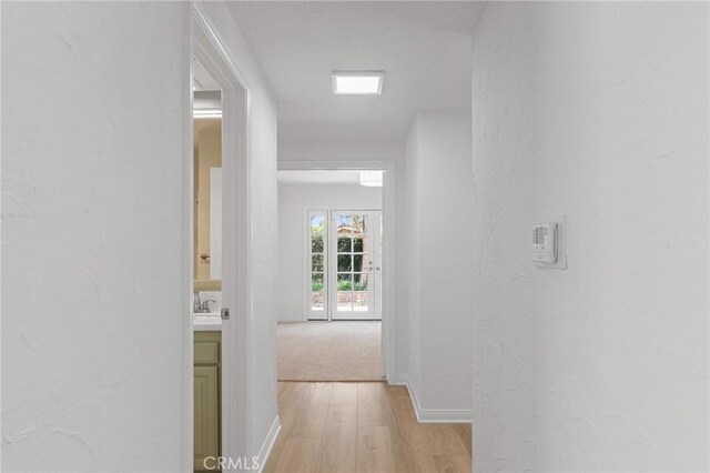 6210 Riverside Ave, Rialto, CA 92377 - corridor with light wood-type flooring and a textured wall