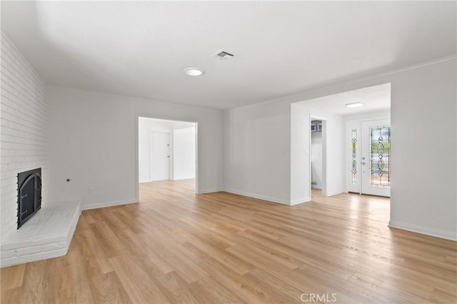 6210 Riverside Ave, Rialto, CA 92377 - unfurnished living room with light wood-style flooring and a fireplace