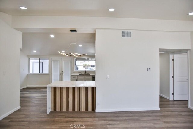 13282 Cherry St, Westminster, CA 92683 - kitchen with dark wood finished floors, recessed lighting, a chandelier, light countertops, and a peninsula