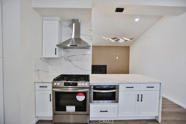 13282 Cherry St, Westminster, CA 92683 - kitchen with stainless steel appliances, wall chimney range hood, white cabinets, and light stone counters
