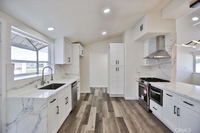 13282 Cherry St, Westminster, CA 92683 - kitchen featuring wall chimney exhaust hood, appliances with stainless steel finishes, light stone counters, wood finished floors, and white cabinets