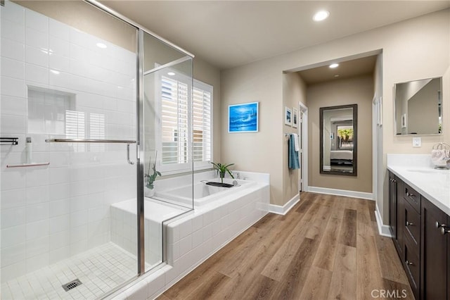 24420 Crooked Trail Dr, Menifee, CA 92584 - bathroom with vanity, a bath, a shower stall, wood finished floors, and recessed lighting