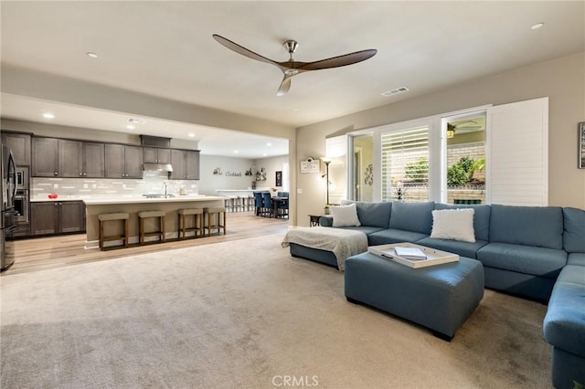 24420 Crooked Trail Dr, Menifee, CA 92584 - living room with a ceiling fan, light colored carpet, and recessed lighting