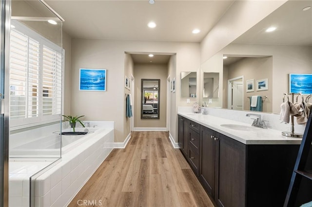 24420 Crooked Trail Dr, Menifee, CA 92584 - full bathroom featuring double vanity, wood finished floors, a garden tub, and recessed lighting