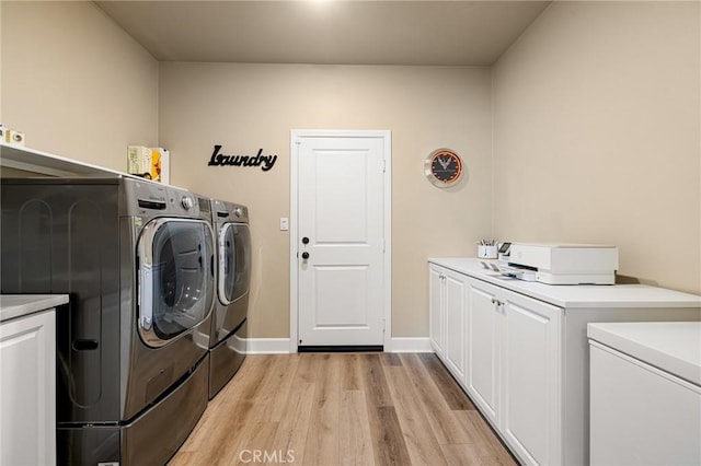 24420 Crooked Trail Dr, Menifee, CA 92584 - washroom featuring washing machine and dryer, cabinet space, and light wood-type flooring
