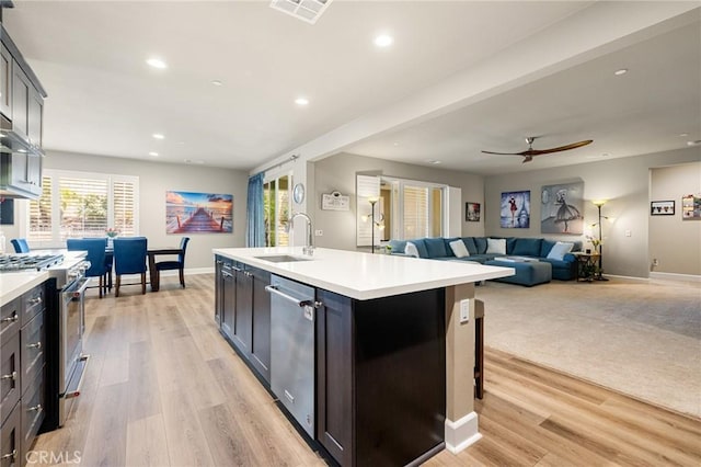 24420 Crooked Trail Dr, Menifee, CA 92584 - kitchen with stainless steel appliances, light countertops, a ceiling fan, recessed lighting, and light wood-style floors