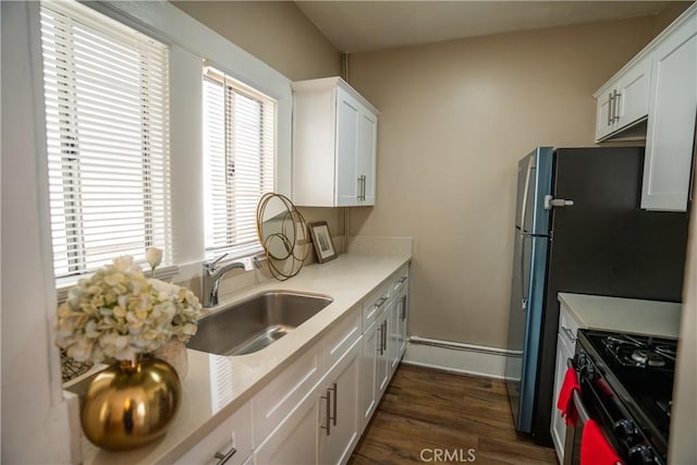 936 Olive Ave, Long Beach, CA 90813 - kitchen featuring range with gas stovetop, light countertops, white cabinets, and dark wood-type flooring