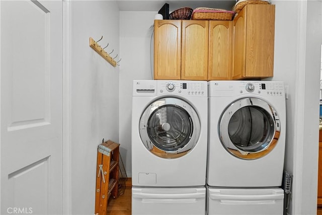 9214 Mclennan Ave, Northridge, CA 91343 - laundry room featuring washing machine and clothes dryer, cabinet space, and wood finished floors