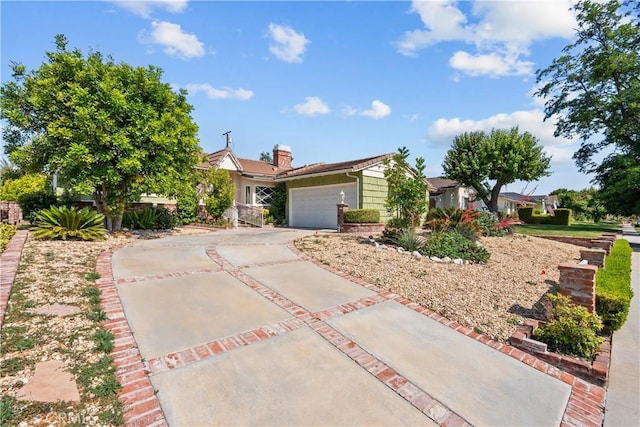 9214 Mclennan Ave, Northridge, CA 91343 - view of front facade featuring concrete driveway, a garage, and a chimney