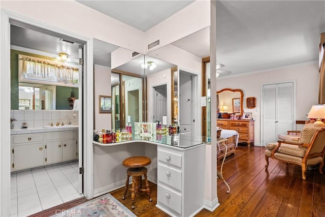 9214 Mclennan Ave, Northridge, CA 91343 - bathroom featuring hardwood / wood-style floors, crown molding, and vanity