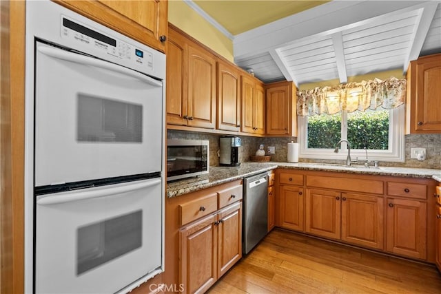 9214 Mclennan Ave, Northridge, CA 91343 - kitchen with appliances with stainless steel finishes, light wood-style floors, light stone counters, backsplash, and beam ceiling
