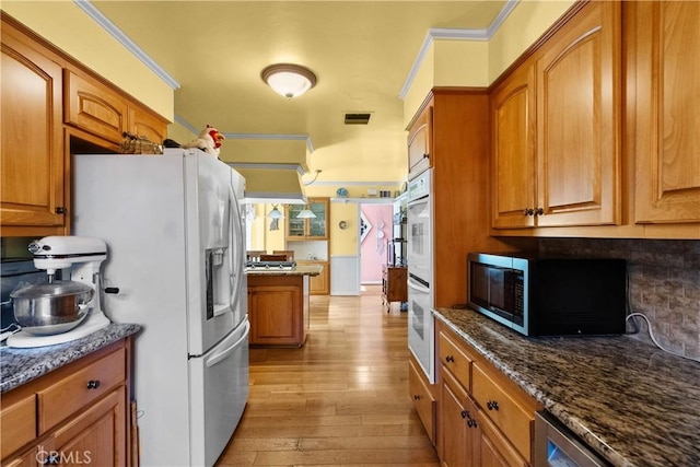 9214 Mclennan Ave, Northridge, CA 91343 - kitchen with white appliances, decorative backsplash, brown cabinetry, light wood-type flooring, and crown molding