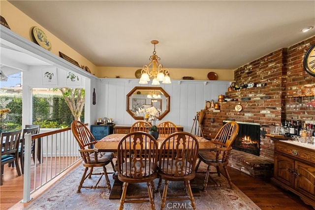 9214 Mclennan Ave, Northridge, CA 91343 - dining room featuring wood finished floors, a chandelier, and a fireplace