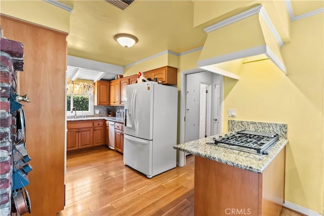 9214 Mclennan Ave, Northridge, CA 91343 - kitchen with white refrigerator with ice dispenser, stainless steel gas cooktop, light wood-type flooring, crown molding, and brown cabinets