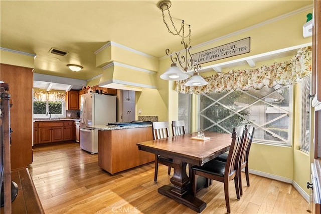9214 Mclennan Ave, Northridge, CA 91343 - dining area featuring light wood finished floors and crown molding