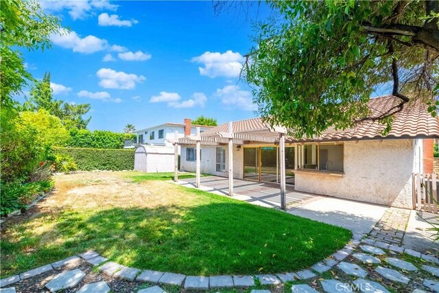 28752 Pisces St, Agoura Hills, CA 91301 - rear view of house featuring a pergola, a storage shed, stucco siding, a fenced backyard, and a patio area