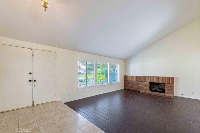28752 Pisces St, Agoura Hills, CA 91301 - unfurnished living room featuring vaulted ceiling, a fireplace, and wood tiled floors