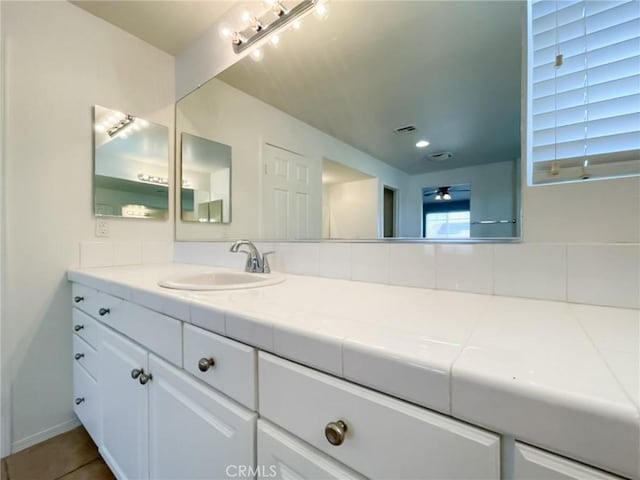 41926 Bonita Dr, Palmdale, CA 93551 - bathroom with vanity, backsplash, tile patterned flooring, recessed lighting, and ceiling fan