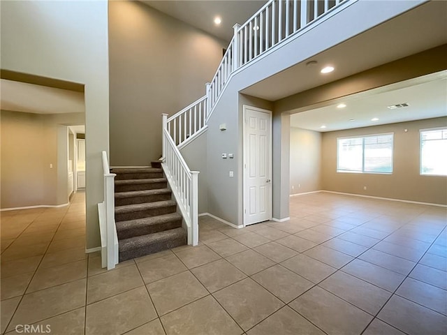 41926 Bonita Dr, Palmdale, CA 93551 - stairway featuring tile patterned flooring, recessed lighting, and a towering ceiling