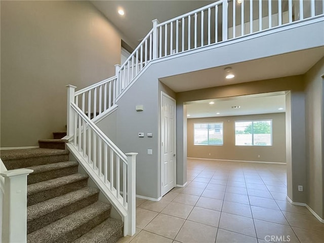 41926 Bonita Dr, Palmdale, CA 93551 - staircase with tile patterned flooring, recessed lighting, and a high ceiling