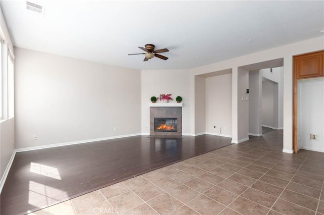 30315 Laruns St, Murrieta, CA 92563 - unfurnished living room featuring a ceiling fan, a tiled fireplace, and tile patterned floors