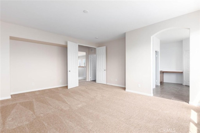 30315 Laruns St, Murrieta, CA 92563 - carpeted empty room with baseboards and arched walkways