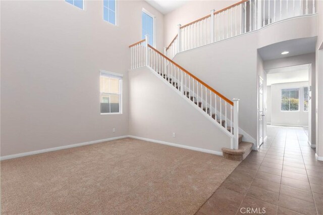 30315 Laruns St, Murrieta, CA 92563 - tiled entryway with a towering ceiling, stairway, and carpet flooring