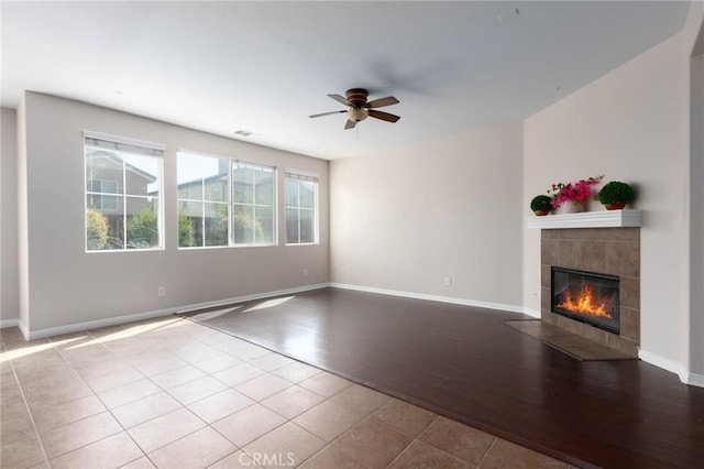 30315 Laruns St, Murrieta, CA 92563 - unfurnished living room featuring ceiling fan, a tile fireplace, and wood finished floors
