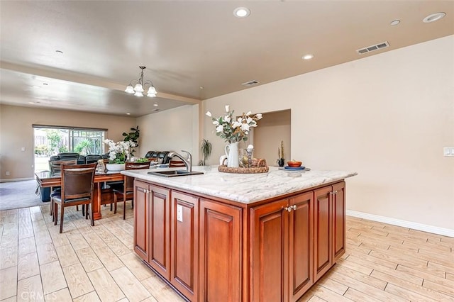 335 E Francis Ave, La Habra, CA 90631 - kitchen featuring light wood-style floors, a chandelier, a center island with sink, decorative light fixtures, and recessed lighting