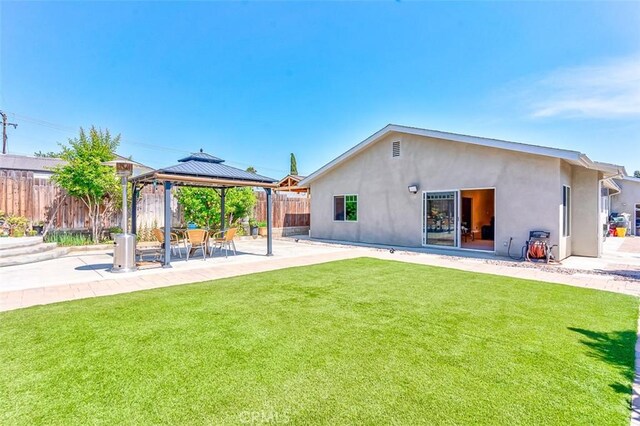 335 E Francis Ave, La Habra, CA 90631 - rear view of house with a gazebo, stucco siding, and a patio area