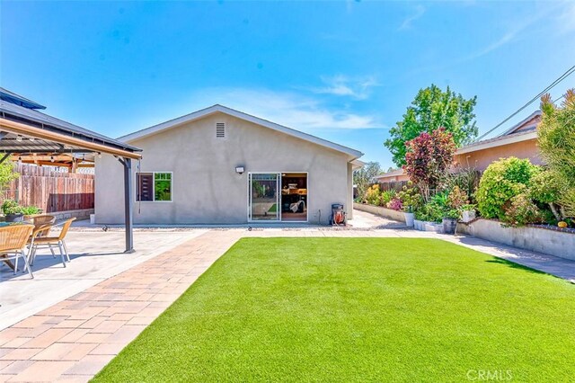 335 E Francis Ave, La Habra, CA 90631 - rear view of house with a gazebo, stucco siding, and a patio area