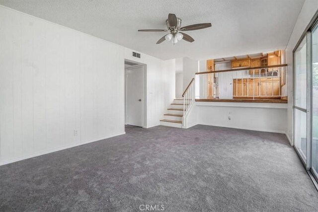 1129 Belbury Dr, Walnut, CA 91789 - unfurnished living room featuring carpet floors, stairs, a ceiling fan, and a textured ceiling