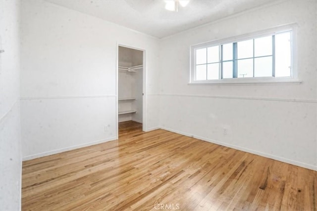 1129 Belbury Dr, Walnut, CA 91789 - unfurnished bedroom with wood finished floors, a closet, a spacious closet, and ceiling fan